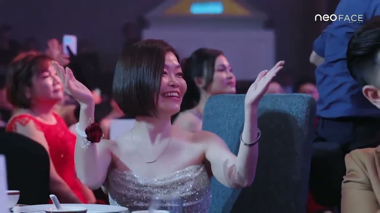 An audience member applauds at an awards night