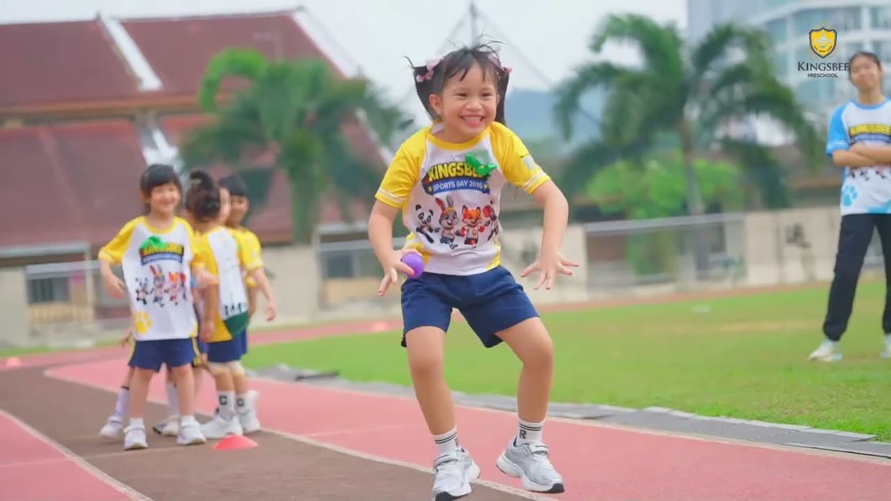 A child dances on the track at a school sports day